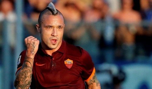 AS Roma's Radja Nainggolan celebrates after his team scores during their Italian Serie A soccer match against Empoli at the Carlo Castellani stadium in Empoli September 13, 2014. REUTERS/Alessandro Bianchi (ITALY - Tags: SPORT SOCCER)